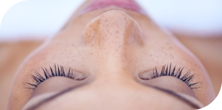 Relaxed client with eyes closed after comprehensive facial waxing treatment