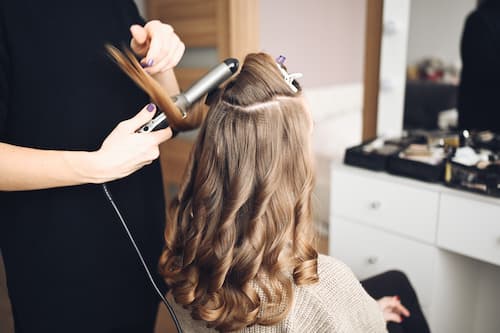 Hair curling and styling service performed by professional stylist