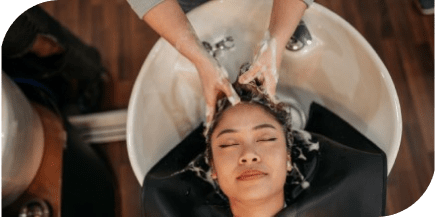 Professional salon shampoo and scalp massage service performed at a hair wash station