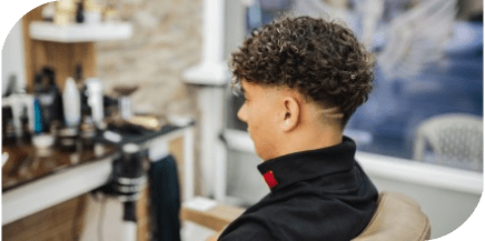 Professional men’s haircut and fade styling with natural curls